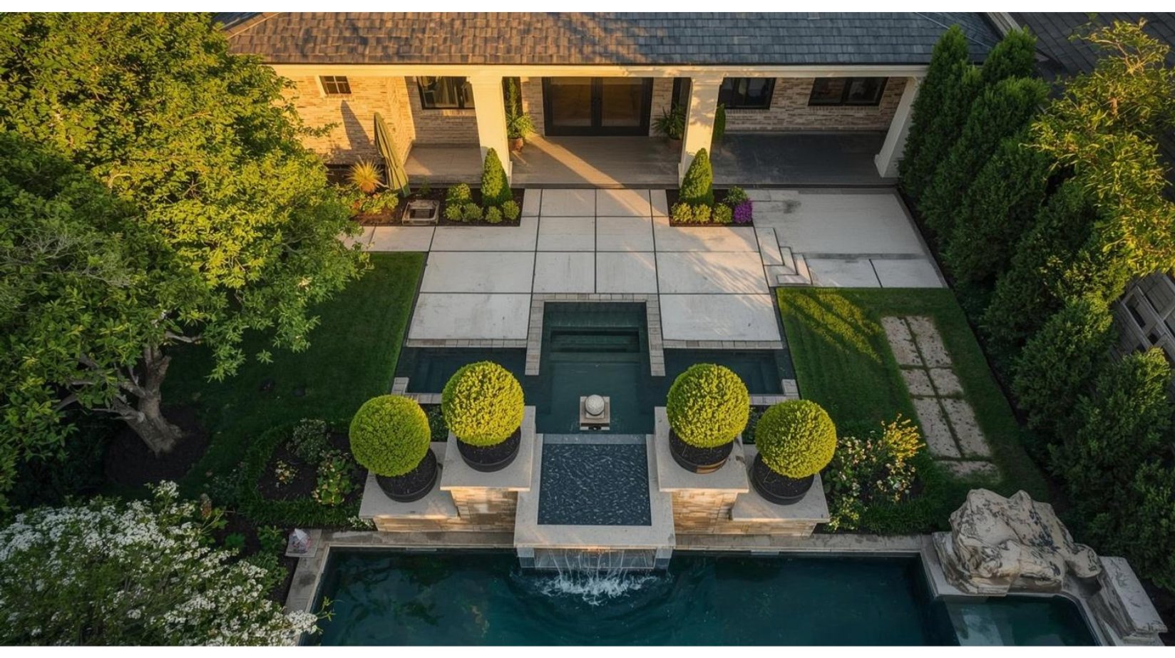Bespoke landscape design in Houston featuring a modern luxury backyard with geometric pool, custom hardscape, and structured plantings