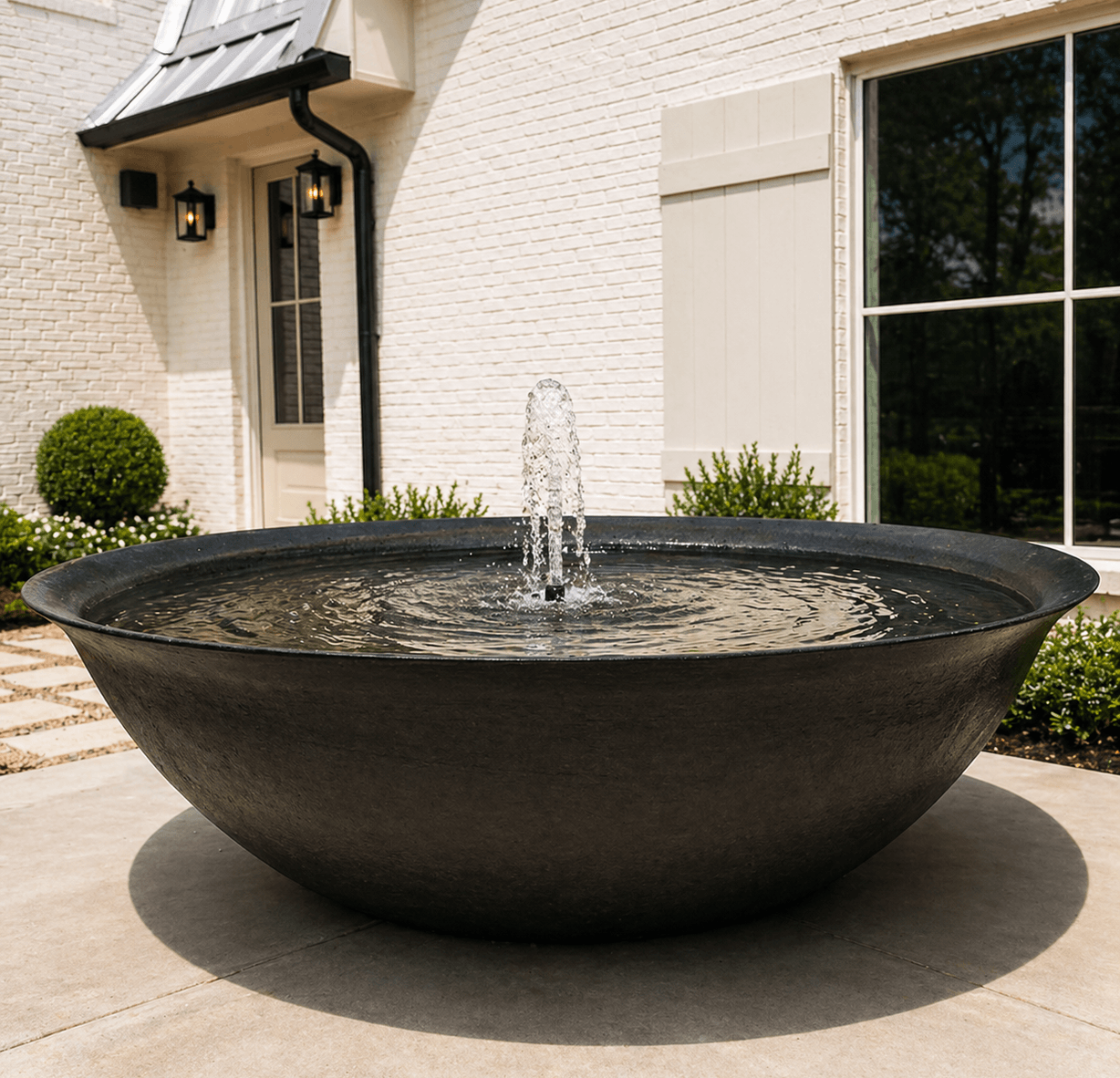 Bowl fountain and planted entry courtyard, the kind of common-area landscaping Strong Landscaping builds in Downtown Houston, TX