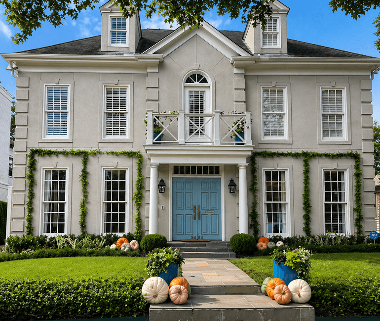 Pumpkins lining the front walkway of a Houston home styled by Strong Landscaping