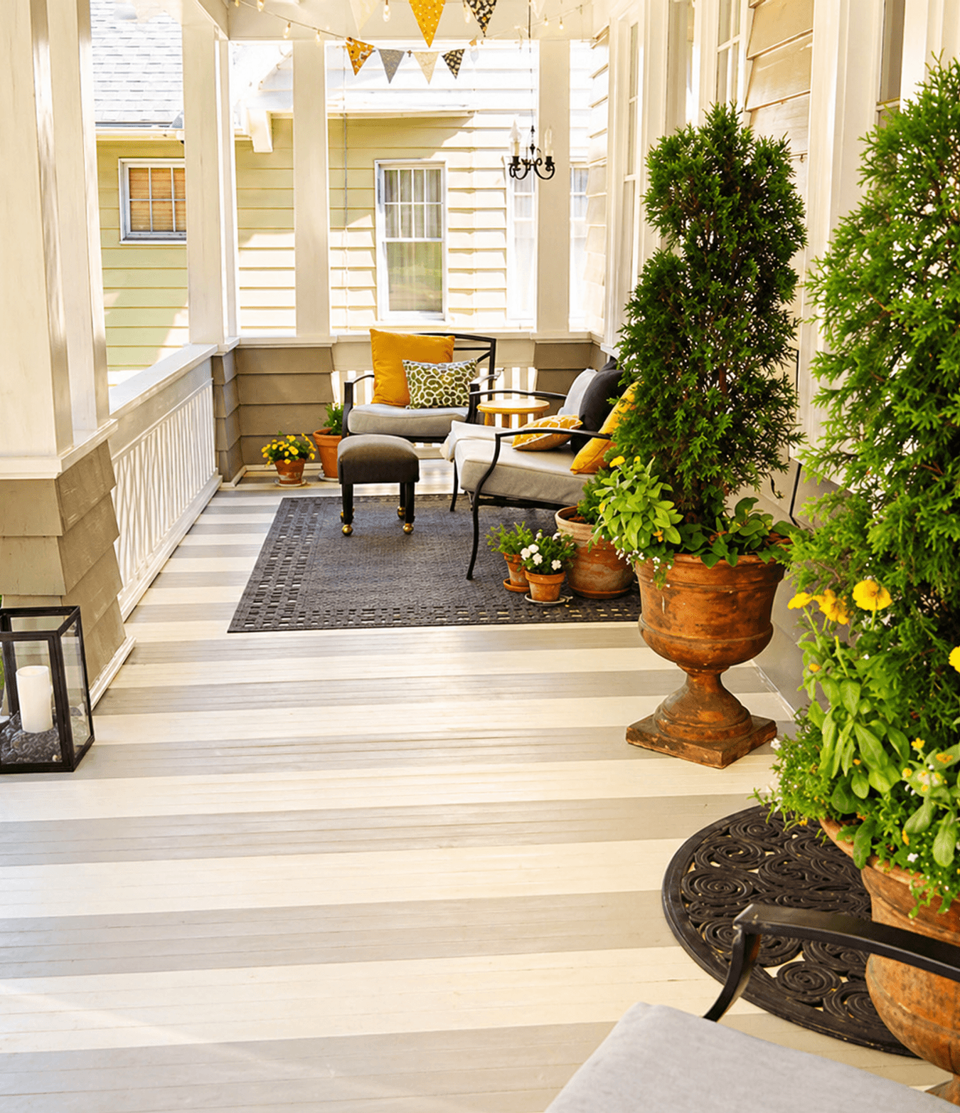 Container planters and outdoor seating on a covered porch, the kind of terrace garden Strong Landscaping builds in Downtown Houston, TX