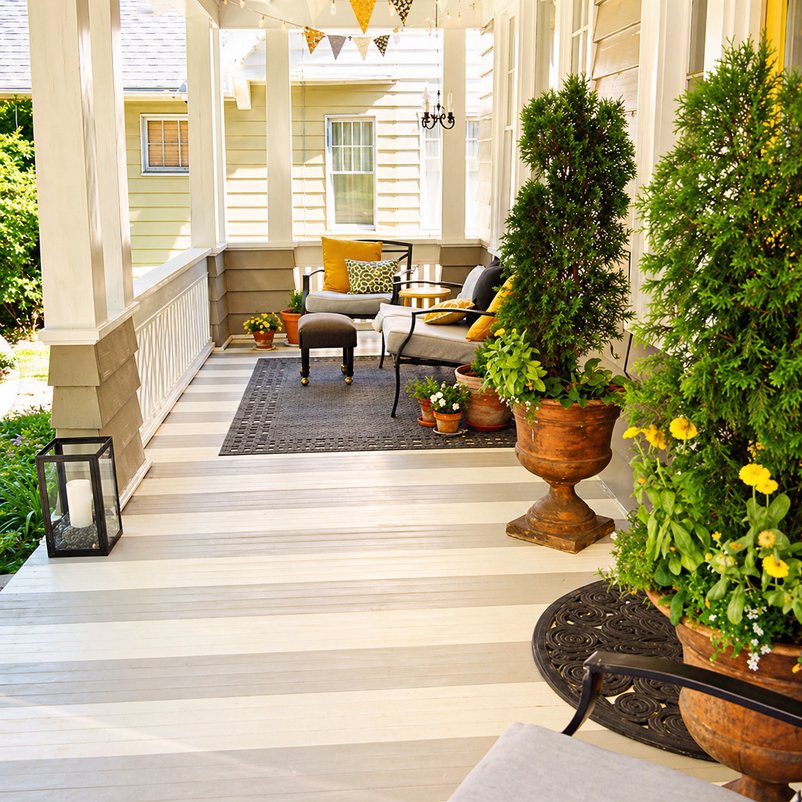 Front porch styled with planters and comfortable outdoor seating