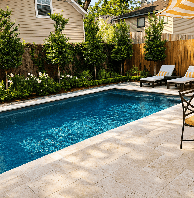 Poolside patio with lounge chairs framed by lush professional landscaping