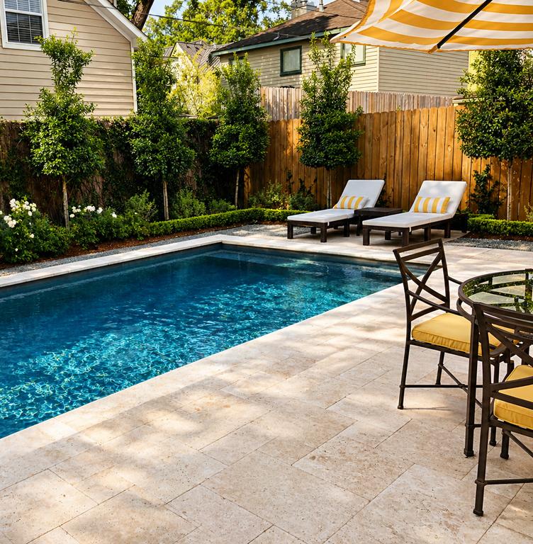 Poolside patio with lounge chairs framed by lush professional landscaping