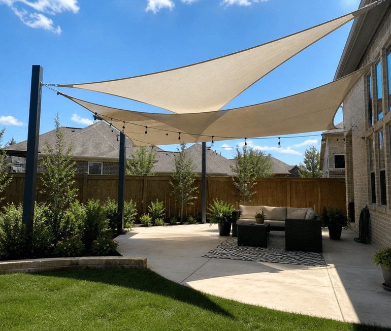 Neutral shade sail installation stretched over a backyard patio for sun protection in Houston