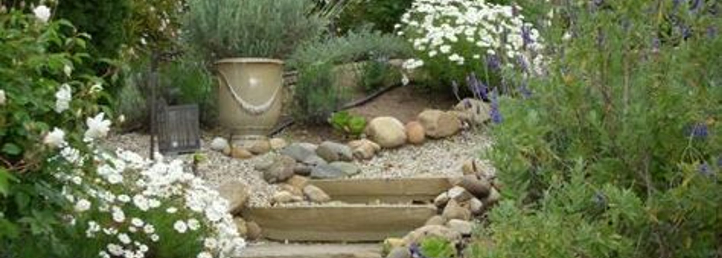 Stone walkway and garden path lined with flower beds built by Strong Landscaping in Upper Kirby, Houston, TX