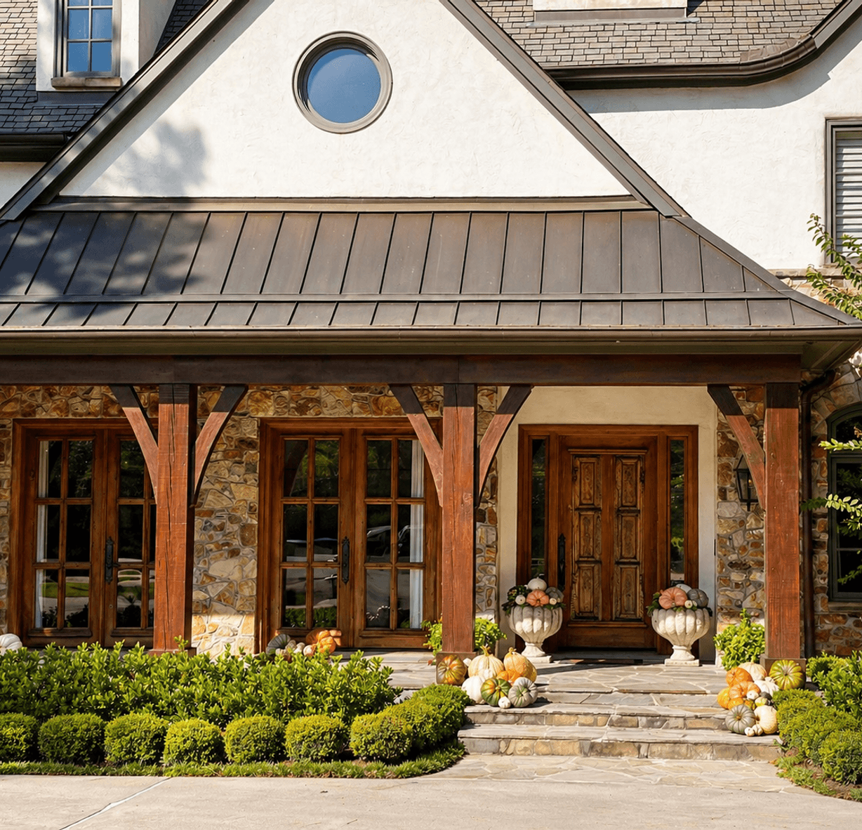 Bungalow front porch with boxwoods and flower beds, planted by Strong Landscaping in Montrose, Houston, TX